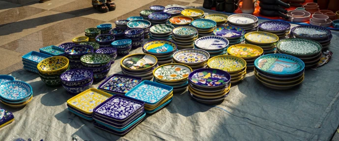 Handmade plates and bowls are displayed on a table.